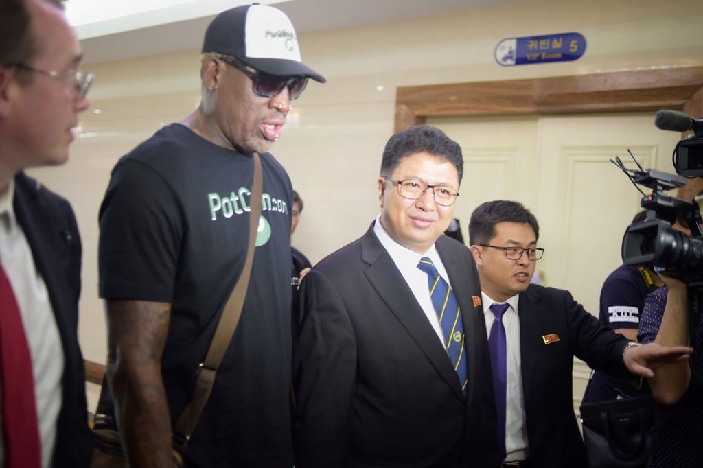 Flamboyant former NBA star Dennis Rodman (2nd L) of the US talks with Son Gwang-Ho (C), North Korea's vice minister for sports and culture, after his arrival at Pyongyang International Airport on June 13, 2017. AFP / Kim Won-Jin
