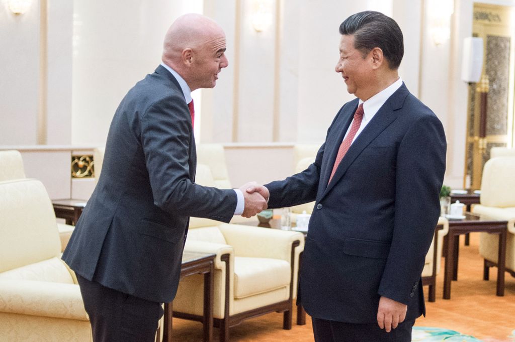 China's President Xi Jinping (R) shakes hands with FIFA President Gianni Infantino at the Great Hall of the People in Beijing on June 14, 2017. / AFP  / Fred DUFOUR
