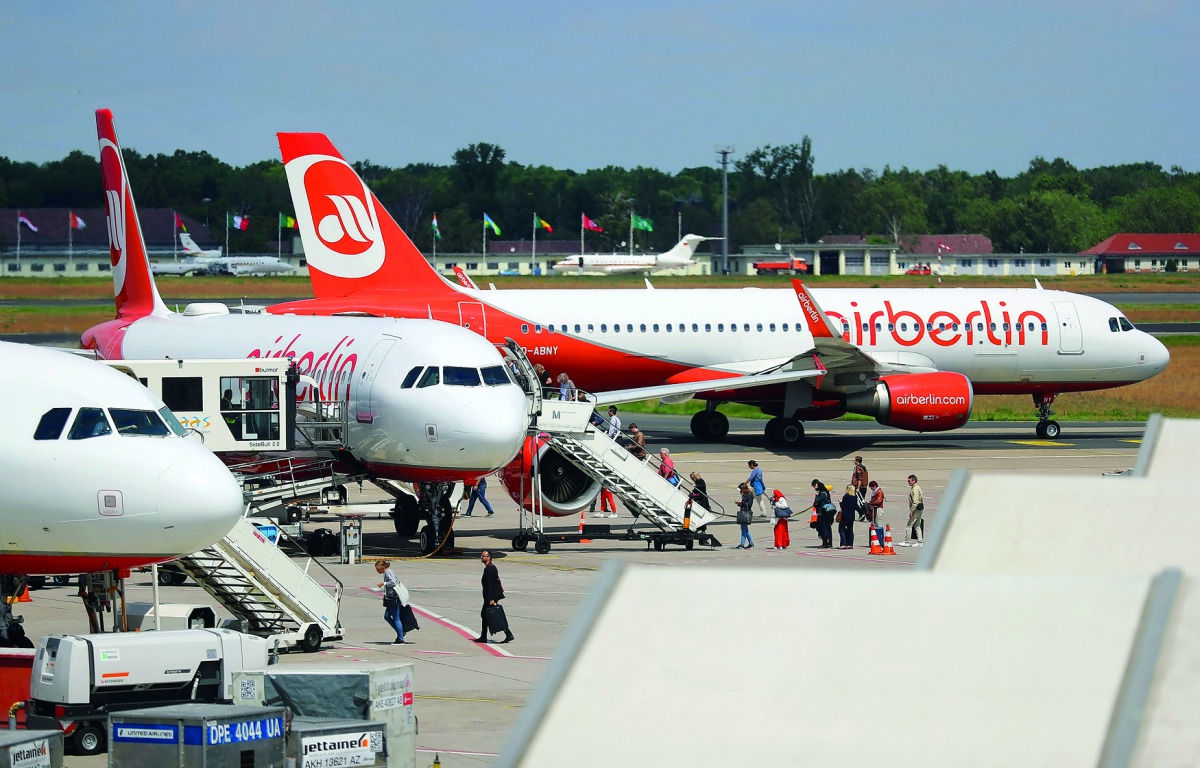 Passengers board a German carrier Air Berlin aircraft at Tegel Airport in Berlin, Germany, yesterday.
