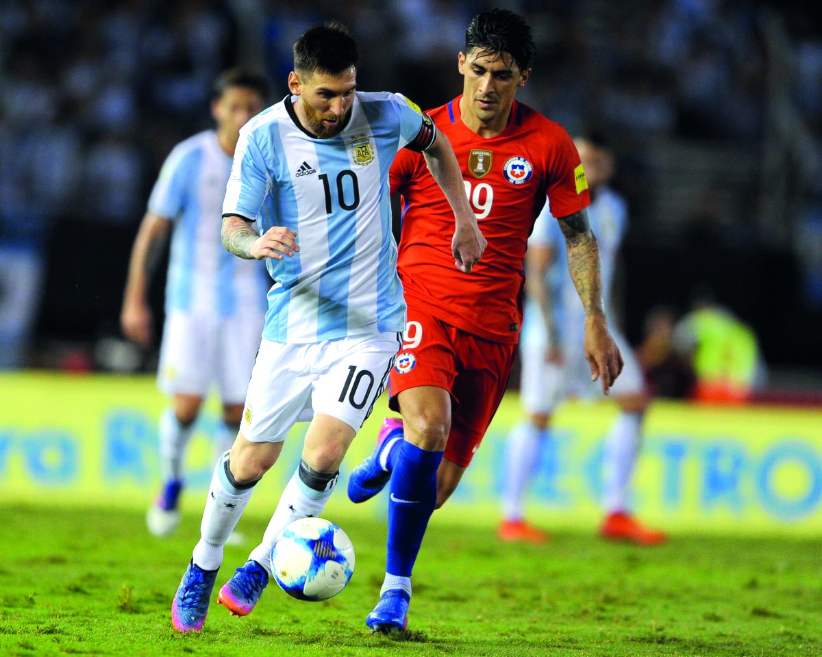 Argentina's Lionel Messi (left) vies for the ball with Chile's Pedro Hernandez during their 2018 FIFA World Cup qualifying match at the Monumental Stadium in Buenos Aires, Argentina, in this March 2017 file photo.