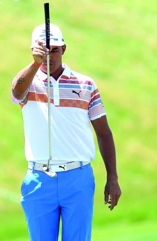Rickie Fowler lines up his putt on the eighth green during the first round of the US Open golf tournament at Erin Hills.