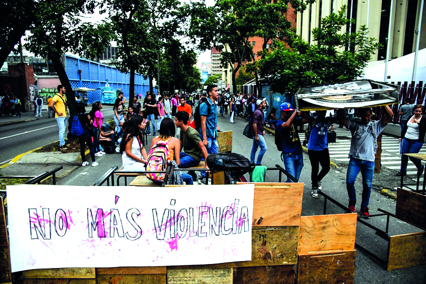 Alejandro Humboldt University students block the street with desks during protests against the National Constituent Assembly prompted by Venezuela's President Nicolas Maduro government, at Romulo Gallegos Avenue in Caracas, yesterday. Near-daily protests 