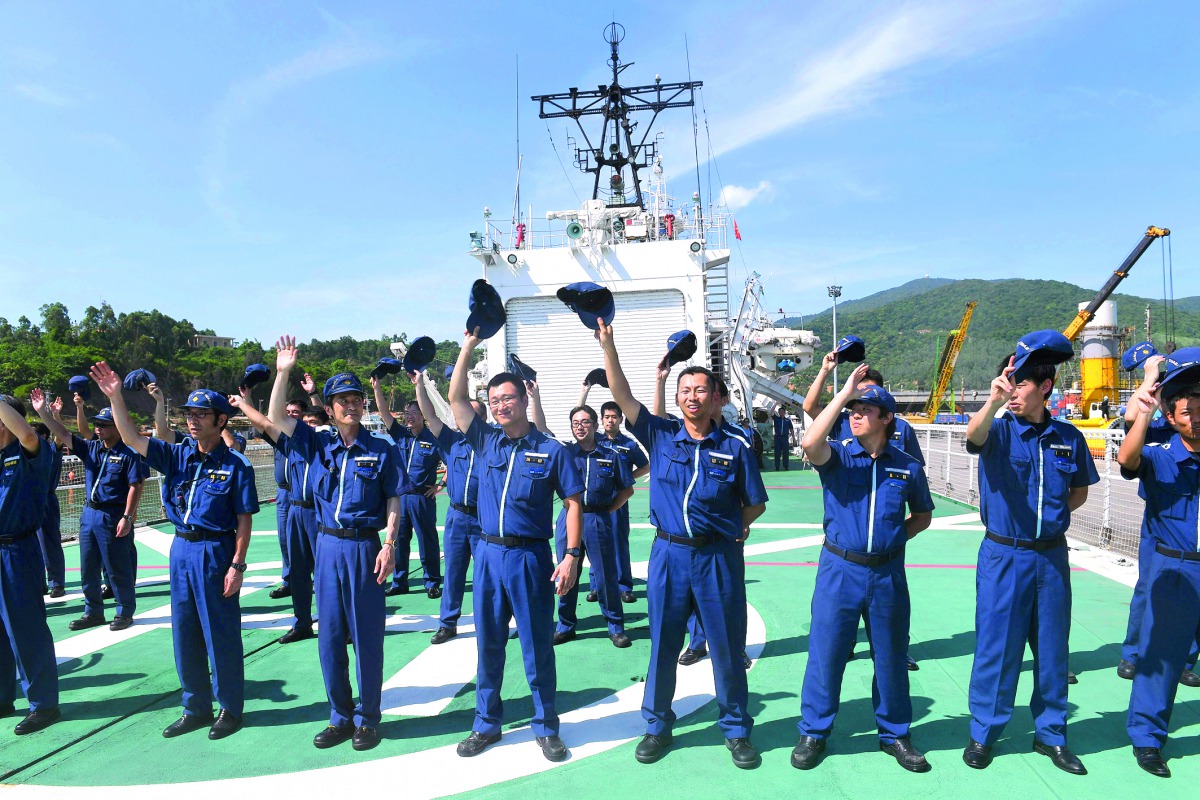 Japan Coast Guard members from the ship Echigo PLH08 wave to Vietnam Coast Guard members at the end of a joint training exercise in the sea off Vietnam's central city of Da Nang, yesterday.