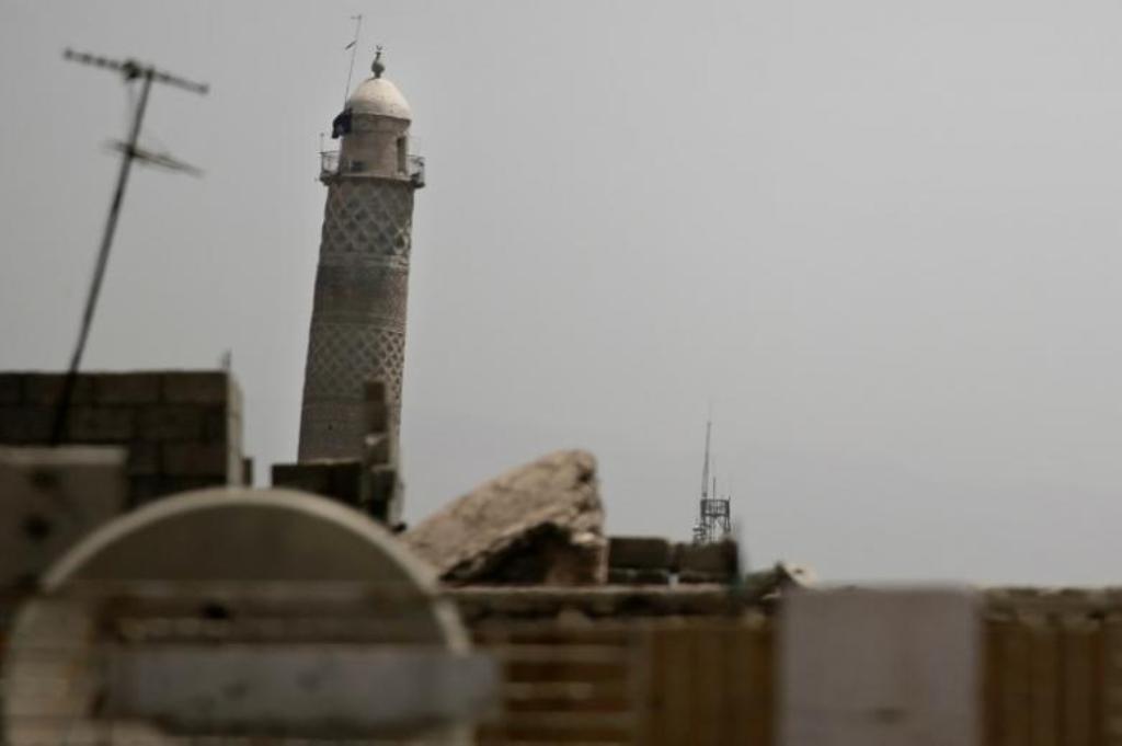 A black jihadist flag hangs from Mosul's Al-Habda minaret at the Grand Mosque, where Islamic State leader Abu Bakr al-Baghdadi declared his caliphate back in 2014, in western Mosul, Iraq May 29, 2017. REUTERS/Alkis Konstantinidis.