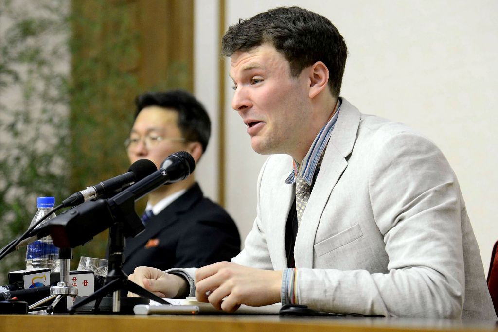 This file photo taken on February 29, 2016 and released by North Korea's official Korean Central News Agency (KCNA) on March 1, 2016 shows US student Otto Frederick Warmbier (R). / AFP.