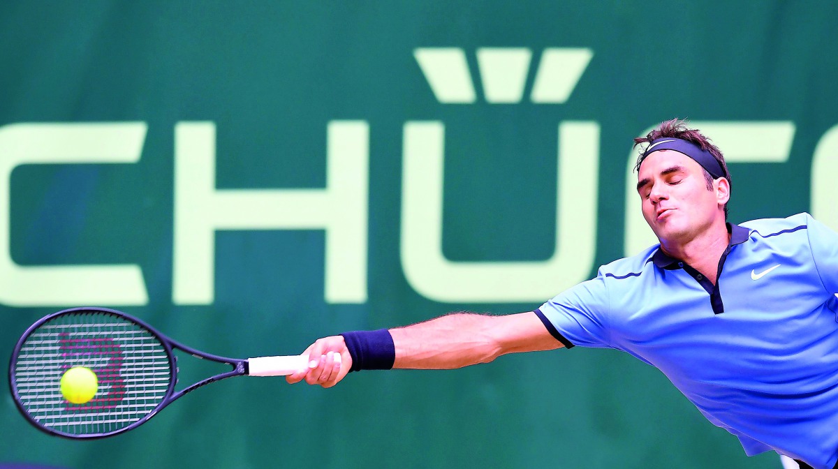 Roger Federer from Switzerland returns the ball to Florian Mayer from Germany during the ATP tournament match in Halle, western Germany, on Friday.