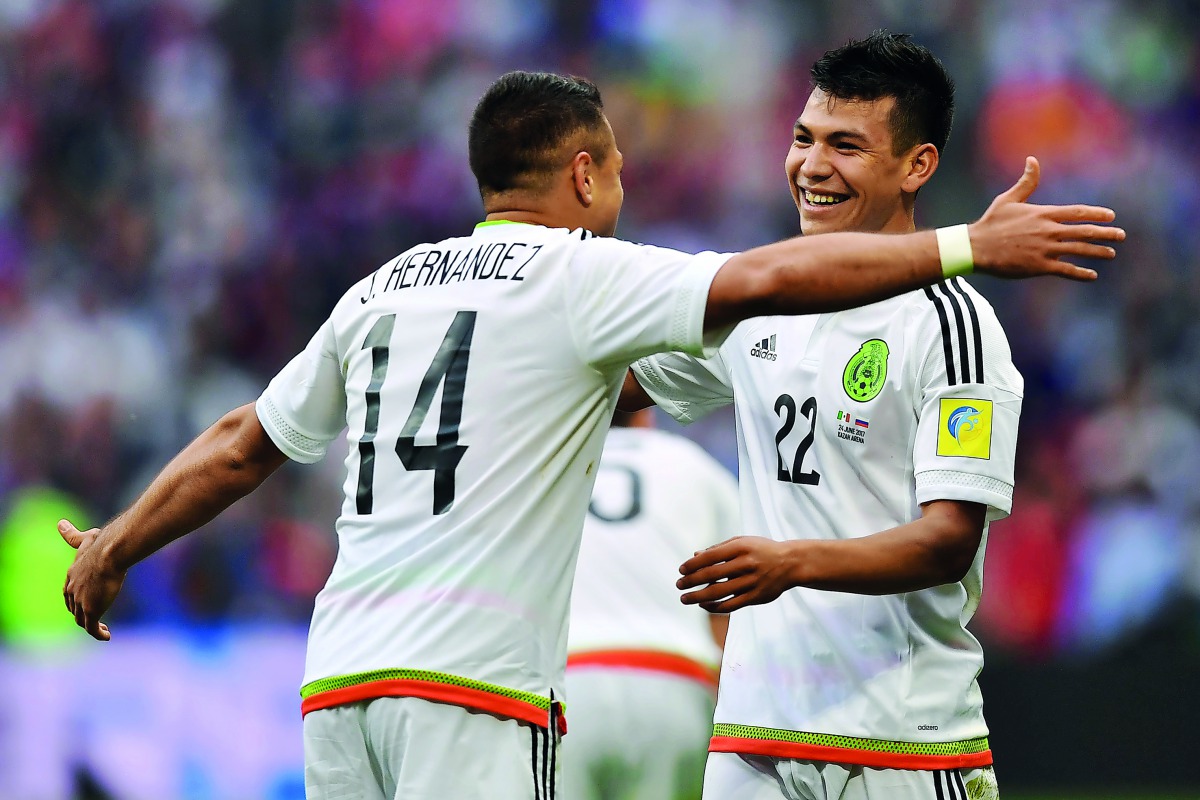 Mexico's forward Javier Hernandez (left) congratulates team-mate Hirving Lozano who scored their second goal during the 2017 Confederations Cup group A match against Russia in Kazan, yesterday.