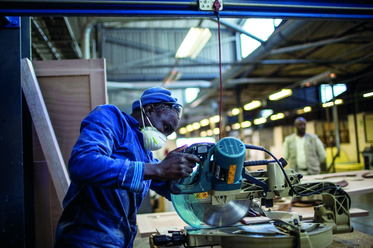 A worker cuts wood at the Furntech Workshop where designers and manufacturers rent out equipment and space to manufacture their products in Johannesburg. Soweto's cottage industries are being transformed from individuals making small quantities for local 
