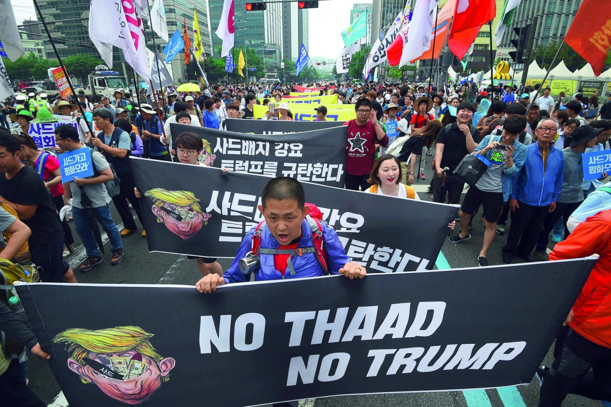 Protesters march towards the US embassy during a rally against the deployment of the US Terminal High Altitude Area Defence (THAAD) system, in Seoul, yesterday.