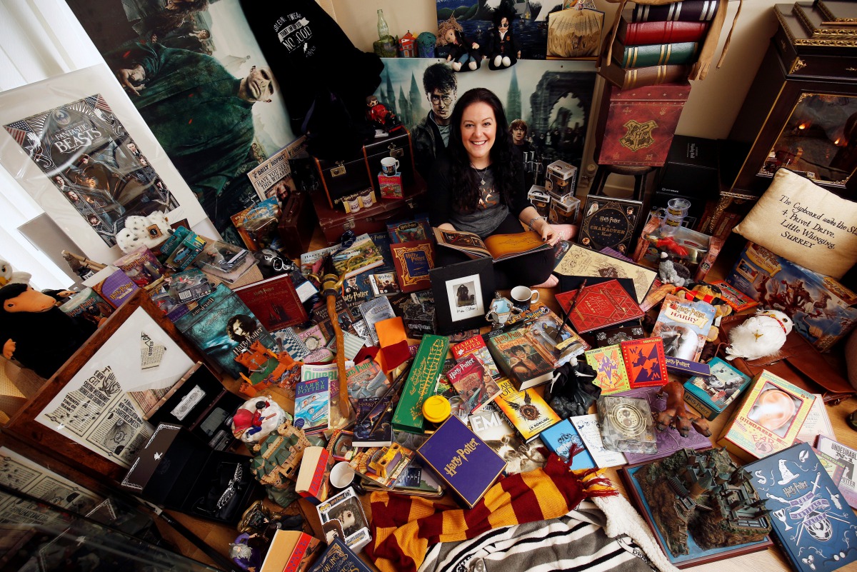 Harry Potter fan Victoria Maclean poses amongst her collection of merchandise at her home in Neath, Britain, February 9, 2017. (REUTERS/Neil Hall)