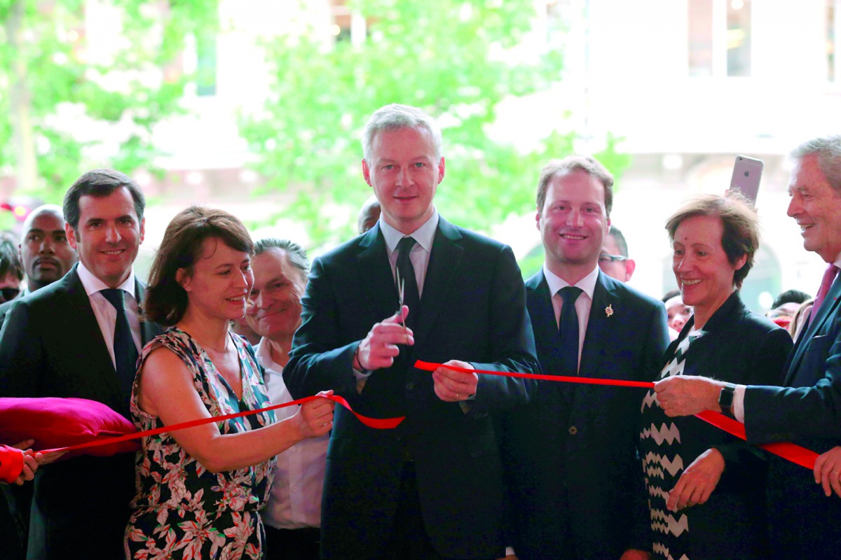 French Economy Minister Bruno Le Maire cutting the ribbon to launch the summer sales of a French department store in Paris, yesterday.