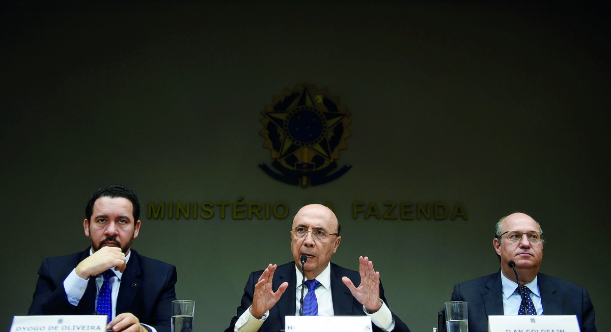 Brazilian Finance Minister Henrique Meirelles (centre), Planning Minister Dyogo Oliveira (left) and Central Bank of Brazil President Ilan Goldfajn addressing the press in Brasilia, Brazil, yesterday. The National Monetary Council announced after a meeting