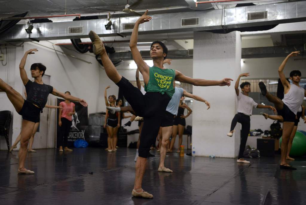 In this picture taken June 27, 2017, Indian ballet dancer Amiruddin Shah (in green) practises at a dance academy in Mumbai. AFP / PUNIT PARANJPE