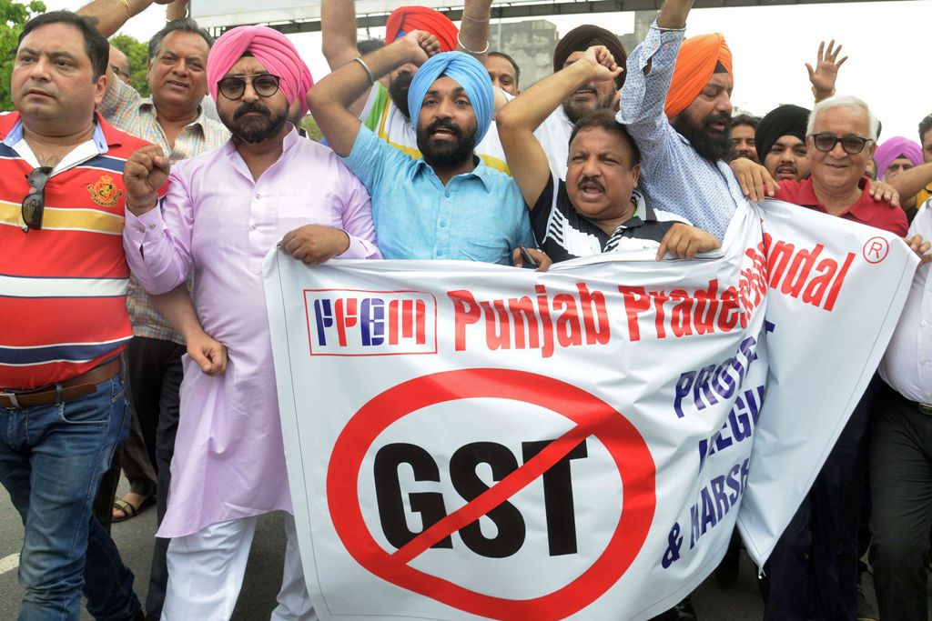 This photo taken on June 30, 2017 shows Indian traders protesting against the forthcoming Goods and Services Tax (GST) during a demonstration outside a tax office in Amritsar. AFP / NARINDER NANU 