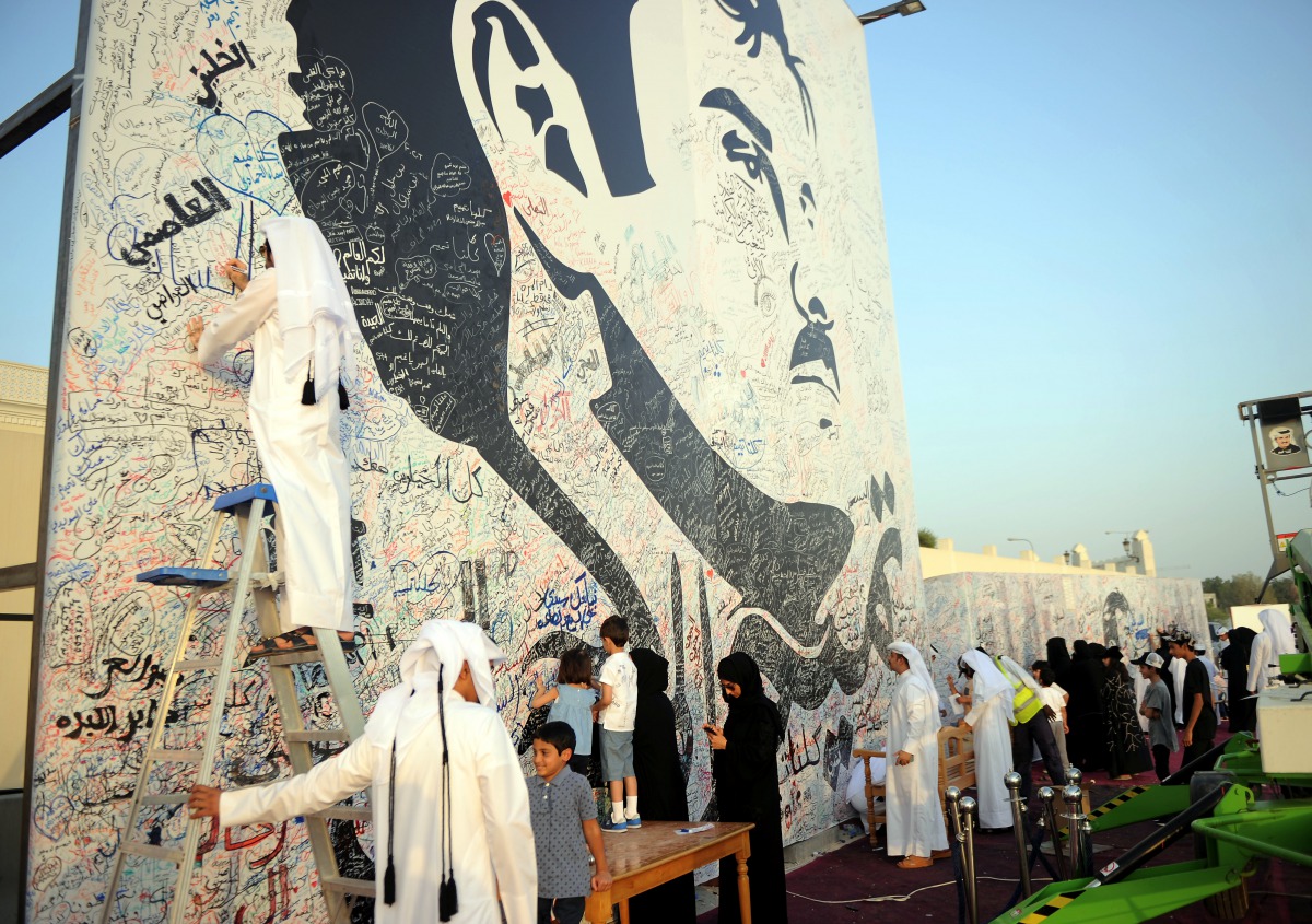 people signing on the Huge painting of Emir HH Sheikh Tamim bin hamad al Thani to show there solidarity with the leadership in this hour of crisis on Monday in Al Gharafa. Pic: Abdul Basit