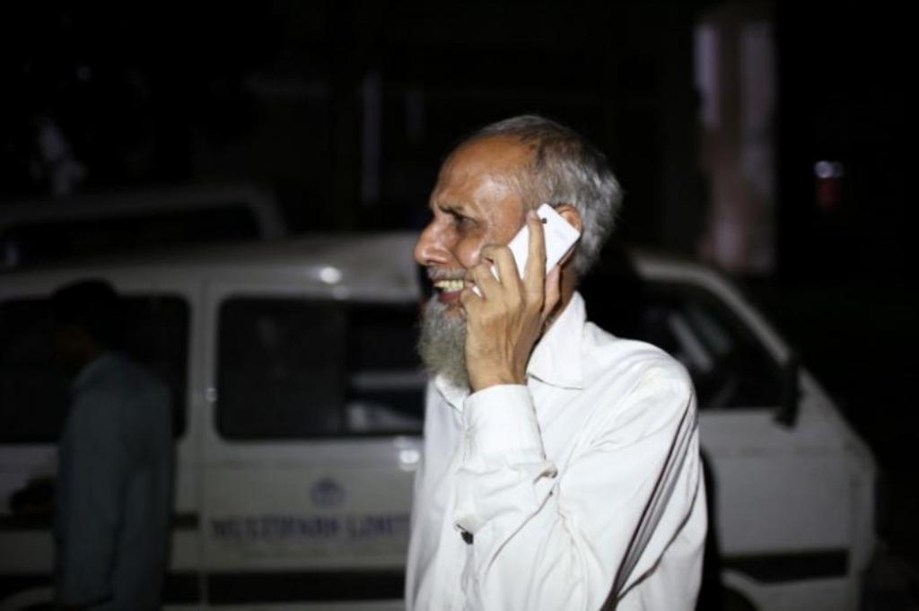 A man, who lost his daughter-in-law, cries while talking on the phone following a deadly boiler blast inside a garment factory in Gazipur, Bangladesh, July 4, 2017. REUTERS/Probal Rashid.