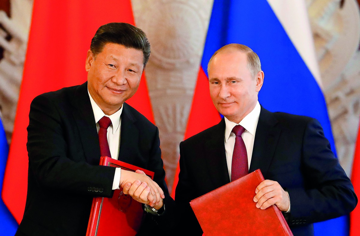 Russian President Vladimir Putin (right) shakes hands with his Chinese counterpart Xi Jinping during a signing ceremony following the talks, on a wide-range of issues, including, economic, trade, investment, diplomacy and politics, at the Kremlin in Mosco