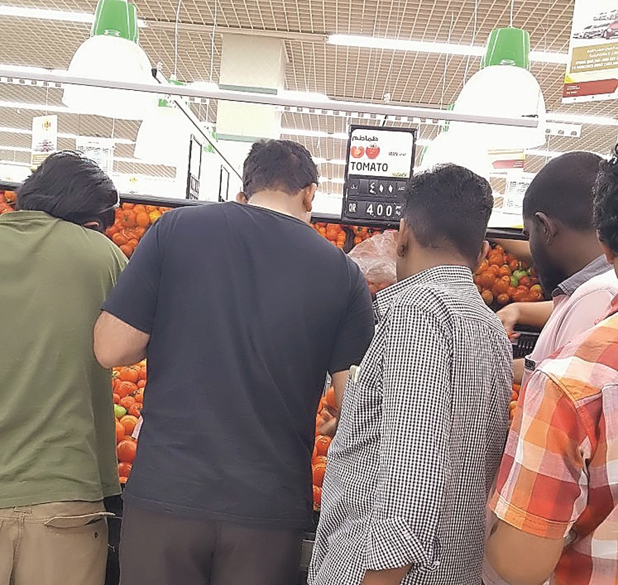 Customers are busy picking tomatoes from the shelve at Lulu Hyper Market in Old Airport, yesterday.