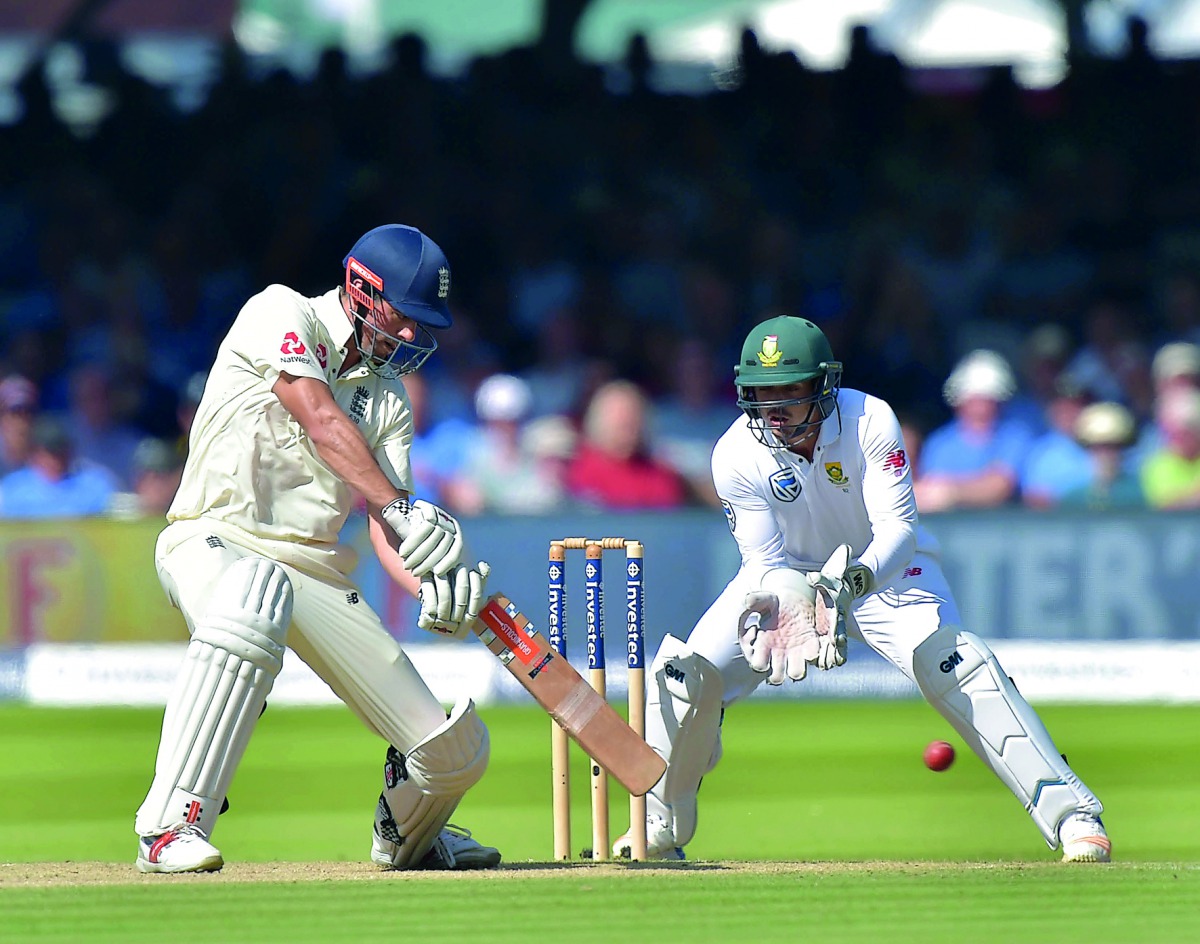 England's Alastair Cook (left) bats as South Africa's Quinton de Kock looks on during the third day of the first Test match at Lord's Cricket Ground in central London. 