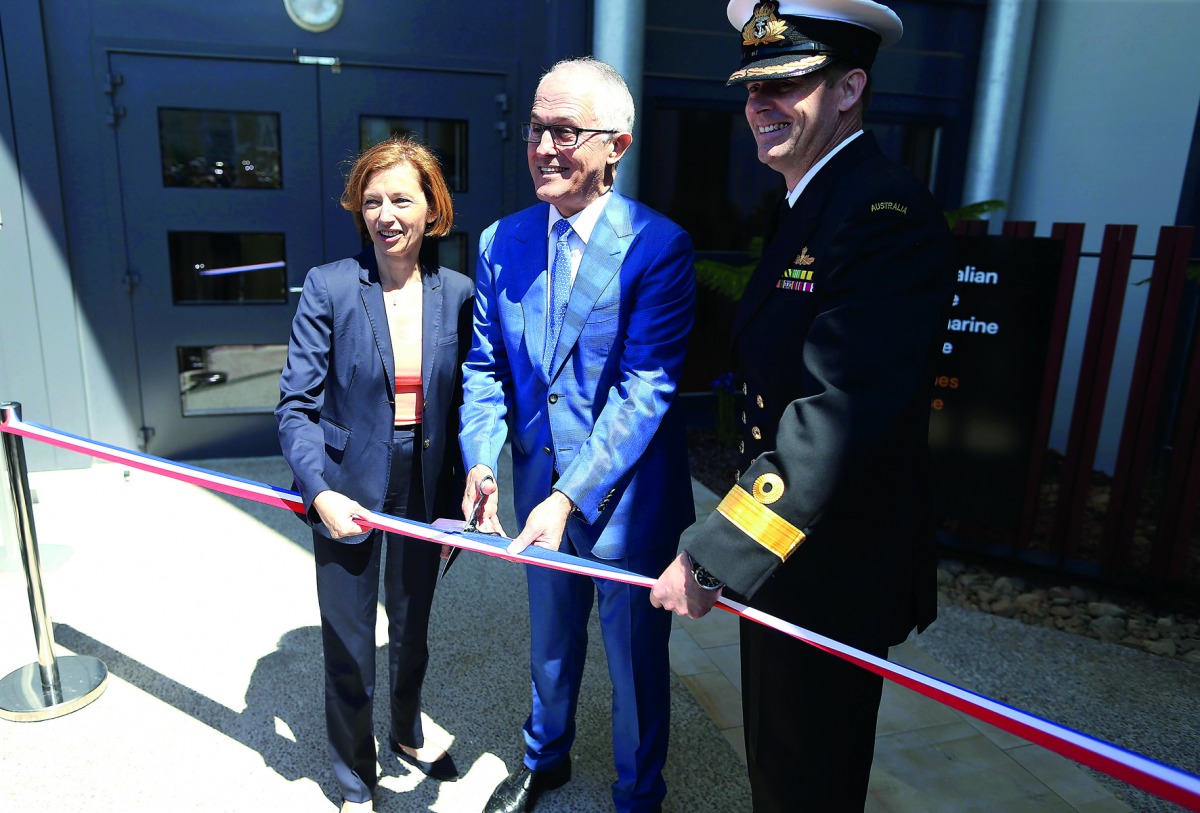 Australian Prime Minister, Malcolm Turnbull (centre) and French Defence Minister, Florence Parly (left), with Royal Australian Navy Commodore, Stephen Hughes during the ribbon cutting ceremony the Naval Group Plant in Cherbourg-Octeville, north-western Fr