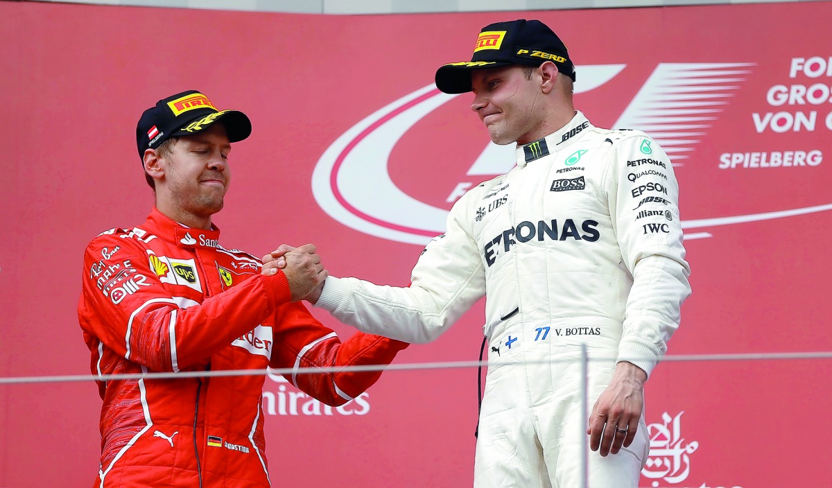Valtteri Bottas celebrates his win on the podium with Ferrari's Sebastian Vettel at the Austrian Grand Prix at the Red Bull Ring in Spielberg, yesterday. 