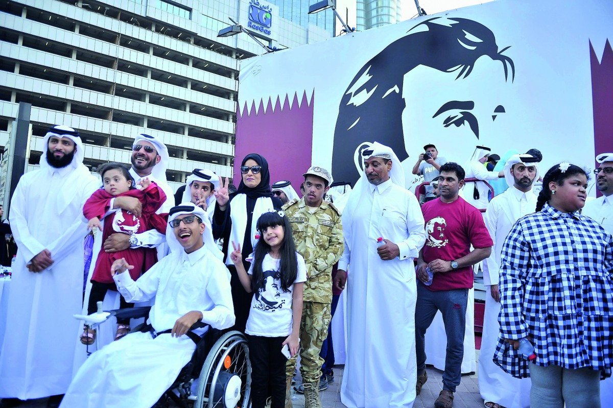Amal bint Abdullatif Al Mannai, CEO of Qatar Foundation for Social Work Group, with supporters in front of the banner of Tamim Al Majd icon at the Tornado Tower yesterday.
Pic: Baher Amin / The Peninsula 