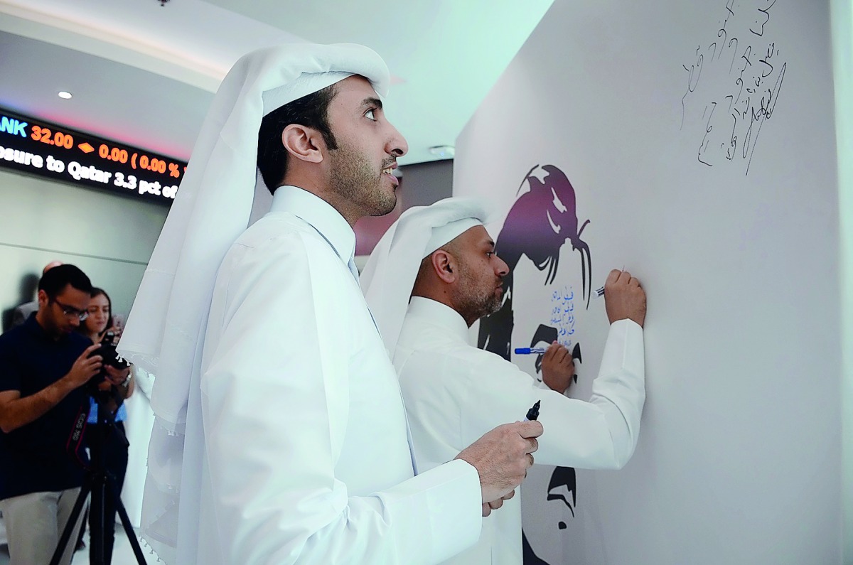 The officials of the QFC signing in the board to express their support for Qatar. 