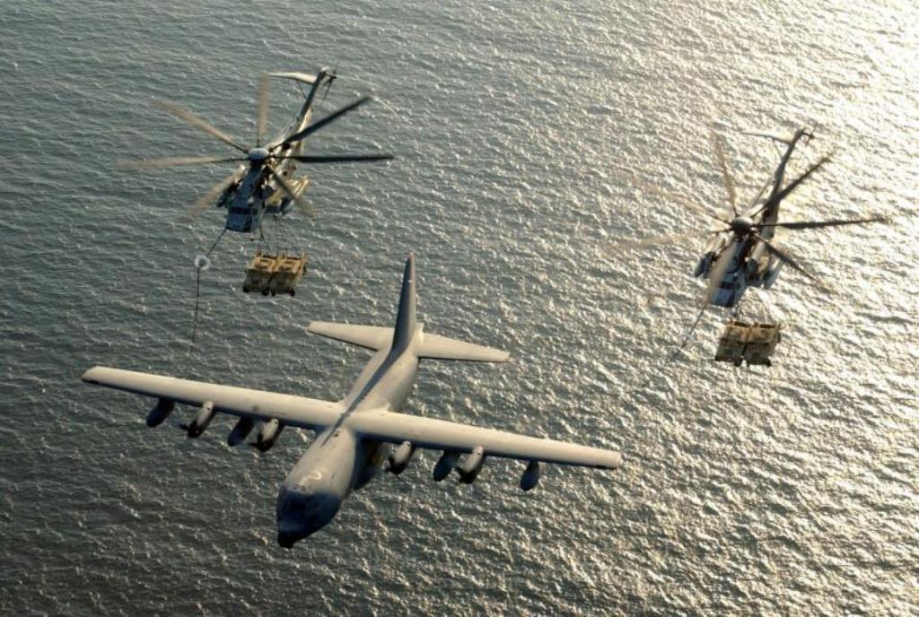 FILE PHOTO: Two U.S. Marine Corps CH-53E Super Stallion helicopters receive fuel from a KC-130 Hercules over the Gulf of Aden January 1, 2003. U.S. Marine Corps/Cpl. Paula M. Fitzgerald/Handout/File Photo via REUTERS.