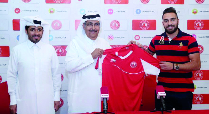 Syrian striker Mardik Mardikian (right) who signed a three-year contract with Al Arabi club poses for a picture during the unveiling ceremony in Doha.