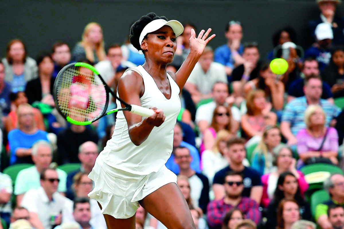 Venus Williams of the US returns against Latvia's Jelena Ostapenko during their women's singles quarter-final match at he 2017 Wimbledon Championships at The All England Lawn Tennis Club in Wimbledon, southwest London, yesterday.