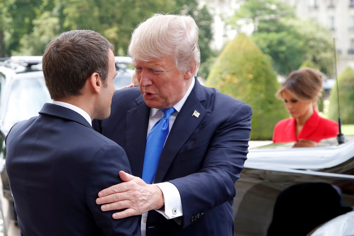 French President Emmanuel Macron (L) greets U.S. President Donald Trump at Les Invalides museum in Paris, France, July 13, 2017. (REUTERS/Michel Euler/Pool)
