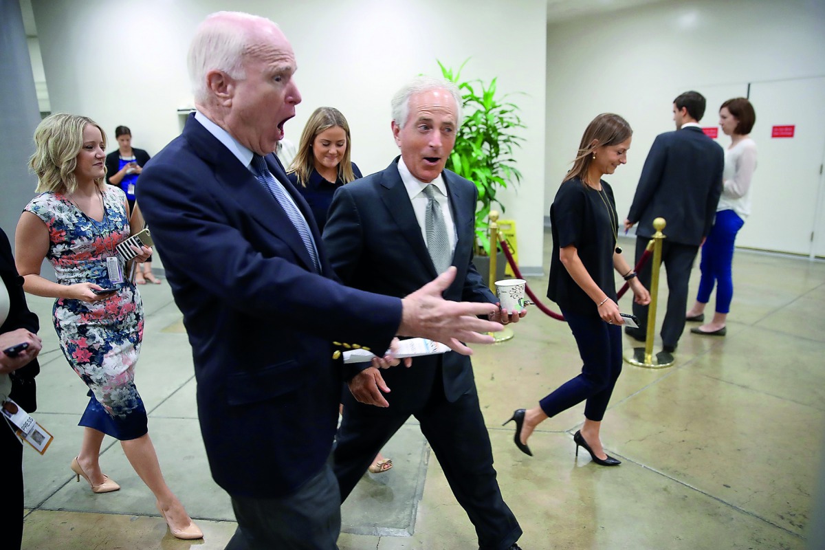 Senators John McCain and Bob Corker walk to a meeting of Republican senators to discuss a new version of their healthcare bill at the US Capitol in Washington, DC, yesterday.