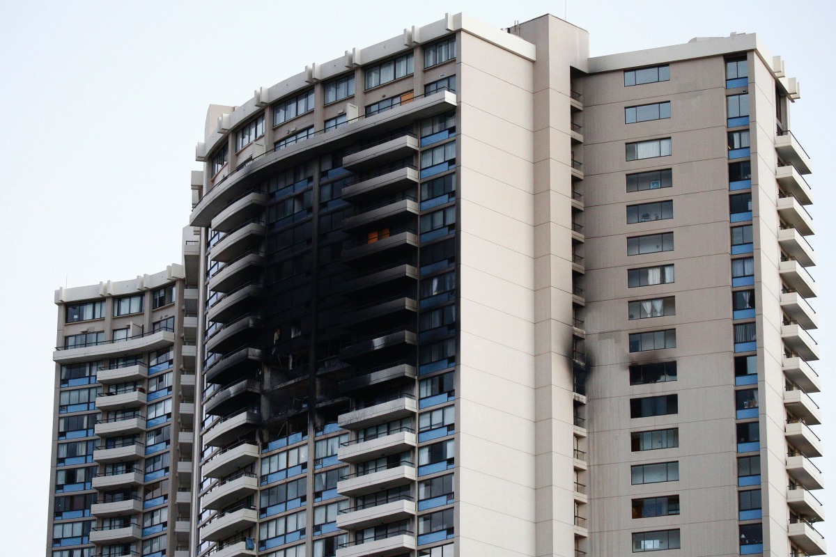 The charred exterior of the Marco Polo Building is pictured after a fire broke out on the upper floors in Honolulu, Hawaii, on July 14, 2017. At least three people were killed and a dozen injured when a massive fire tore through a 36-story apartment compl
