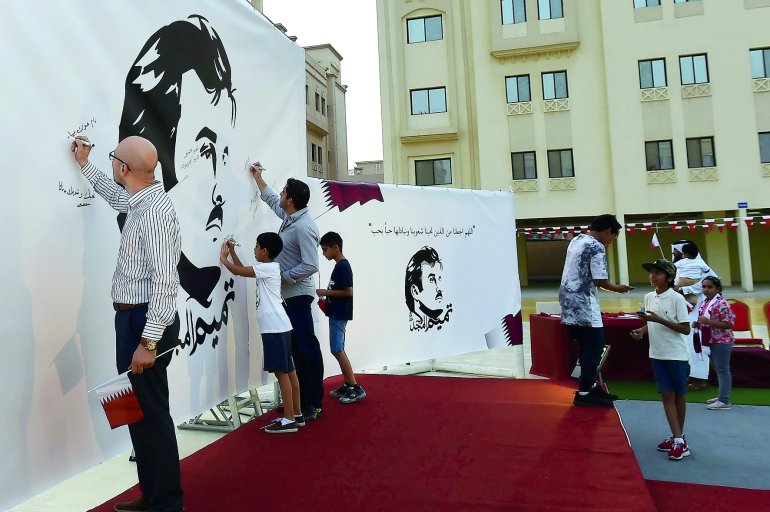 People write messages on 'Tamim Al Majd' murals at Ezdan Village 2 in Al Gharrafa.
