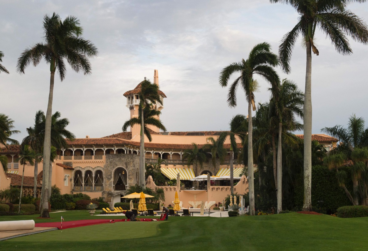 This file photo taken on December 30, 2016 shows workers as they lay out the red carpet at Mar-a-Lago Club in Palm Beach, Florida. AFP / Don Emmert