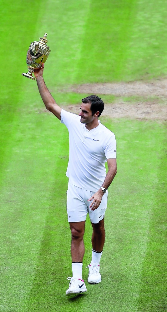 Switzerland’s Roger Federer celebrates with the trophy after winning the final against Croatia’s Marin Cilic REUTERS/John Walton