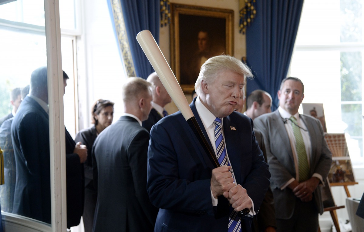 US President Donald Trump examines US-made products from all 50 states, including a Marucci baseball bat, in the Blue Room of the White House during a 