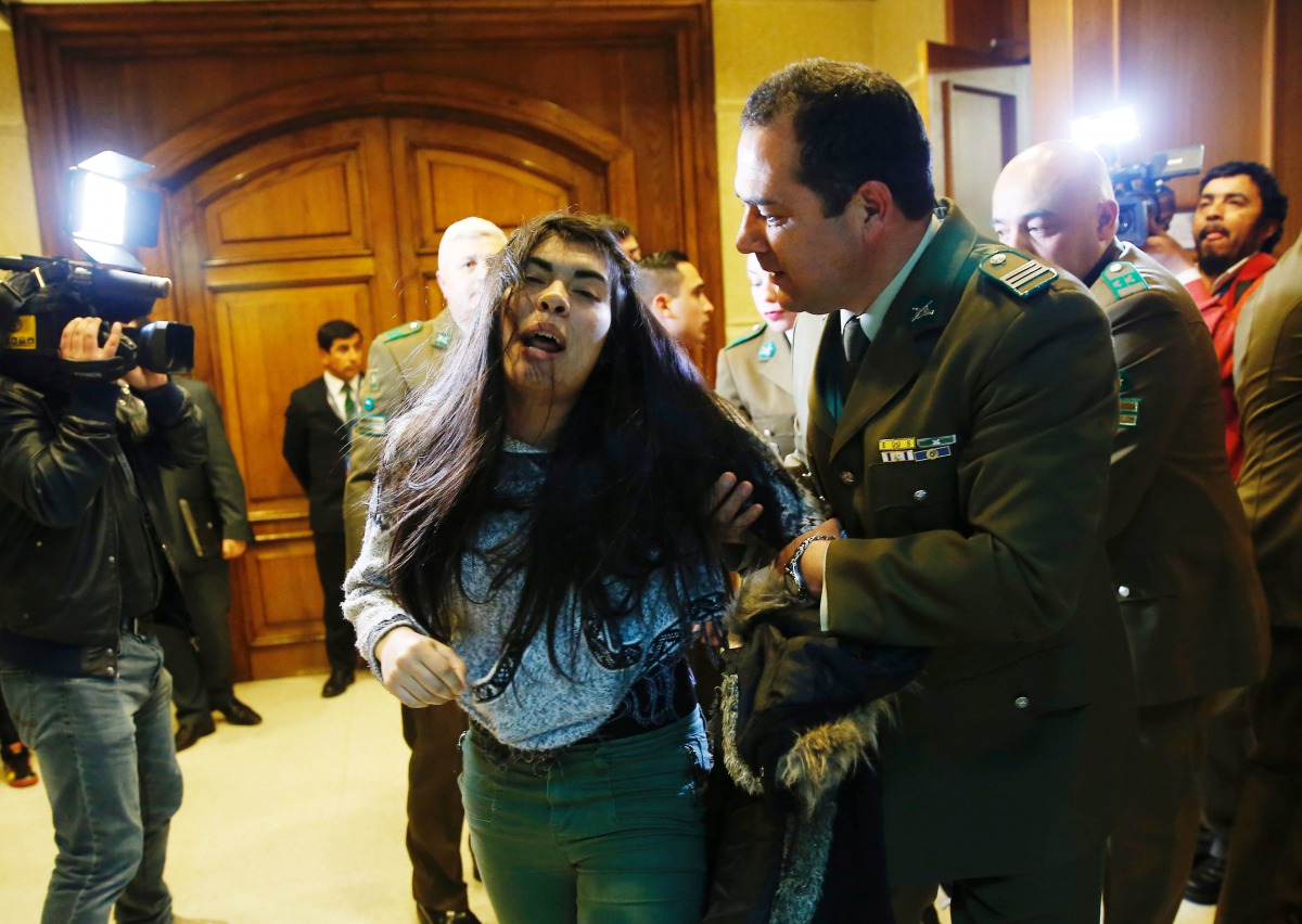 A demonstrator is detained by police officers after shouting slogans against abortion inside the Chilean congress during a session legislating a draft law which seeks to ease the country's strict abortion ban, in Valparaiso, Chile July 18, 2017. Reuters/R