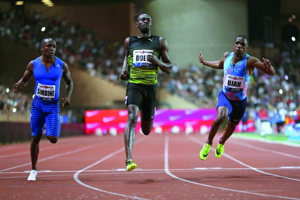 Jamaica’s Usain Bolt (centre) crosses the finish line to win the men’s 100m event at the IAAF Diamond League athletics meeting in Monaco on Friday. Bolt clocked a season’s best of 9.95 seconds.