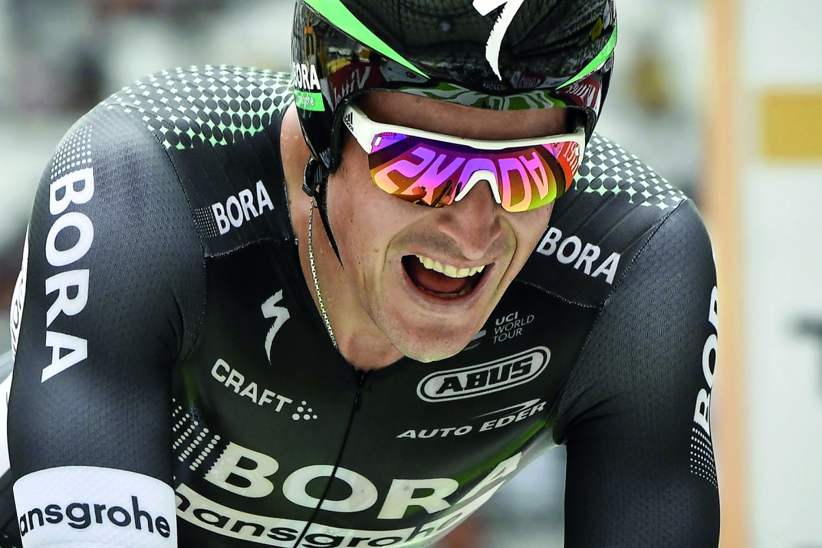 Poland’s Maciej Bodnar crosses the finish line to win  the 20th stage of the Tour de France cycling race.