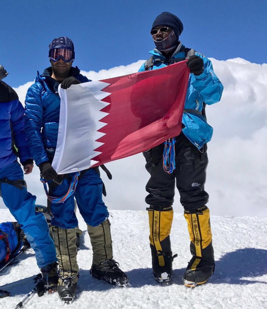The Qatari flag being hoisted atop Mt Elbrus, the highest mountain in Europe.