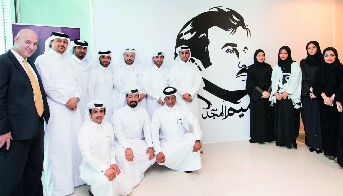 ASTAD officials at the unveiling of a mural of Emir H H Sheikh Tamim bin Hamad Al Thani at the headquarters of the company.