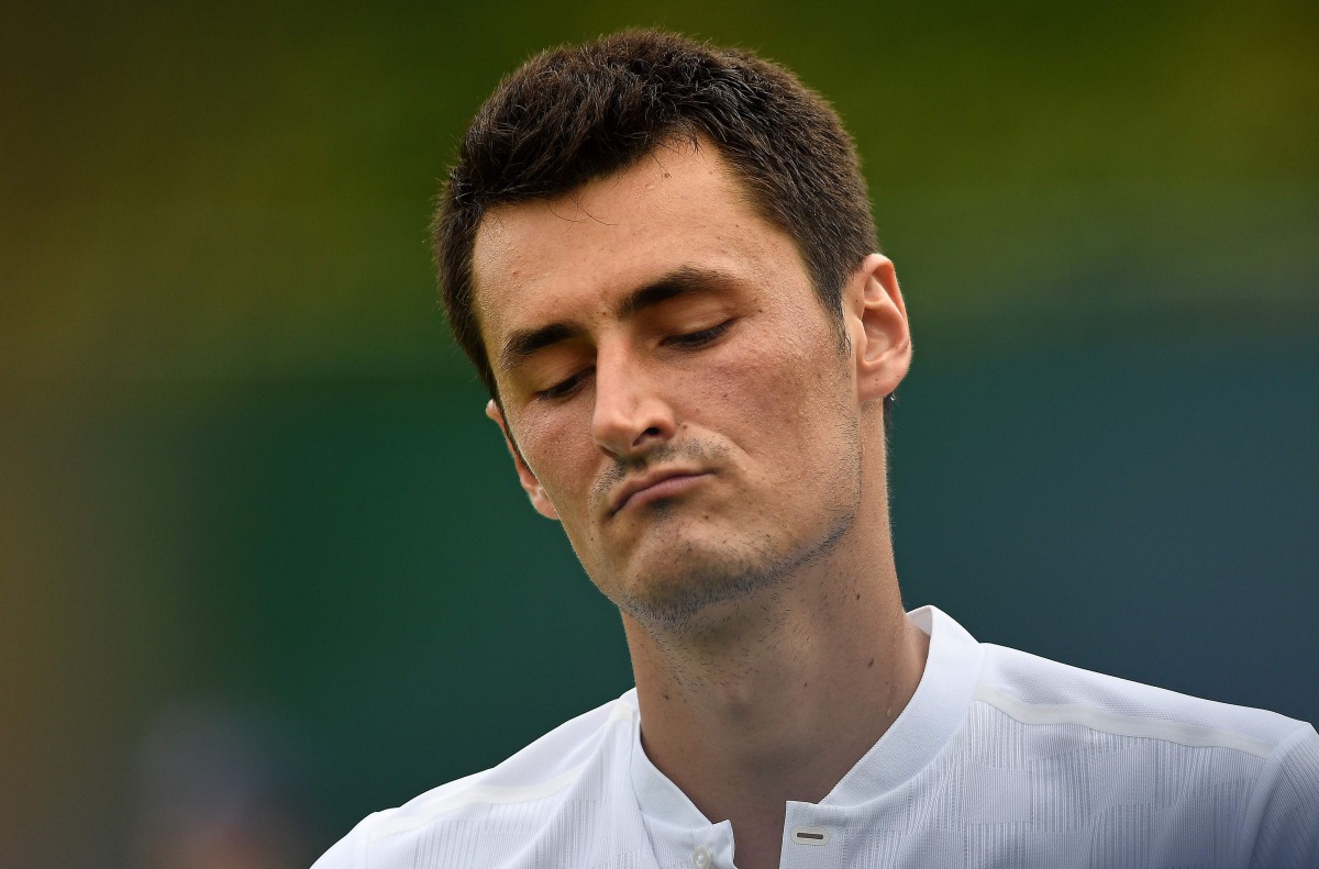 Australia's Bernard Tomic reacting against Germany's Mischa Zverev during their men's singles first round match on the second day at 2017 Wimbledon Championships in London. (AFP / JUSTIN TALLIS)