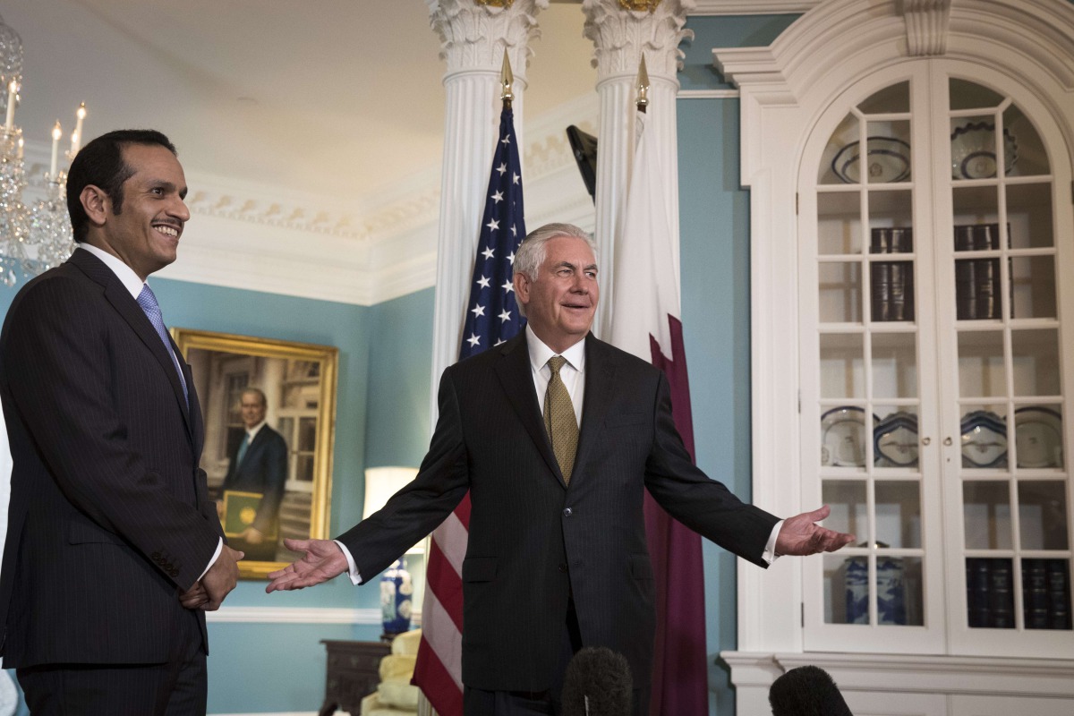 With Qatari Foreign Minister H E Sheikh Mohammed Bin Abdulrahman Al Thani looking on, US Secretary of State Rex Tillerson responds to a question on July 26, 2017 in Washington. When prompted by a reporter, Tillerson said 'I'm not going anywhere' and that 