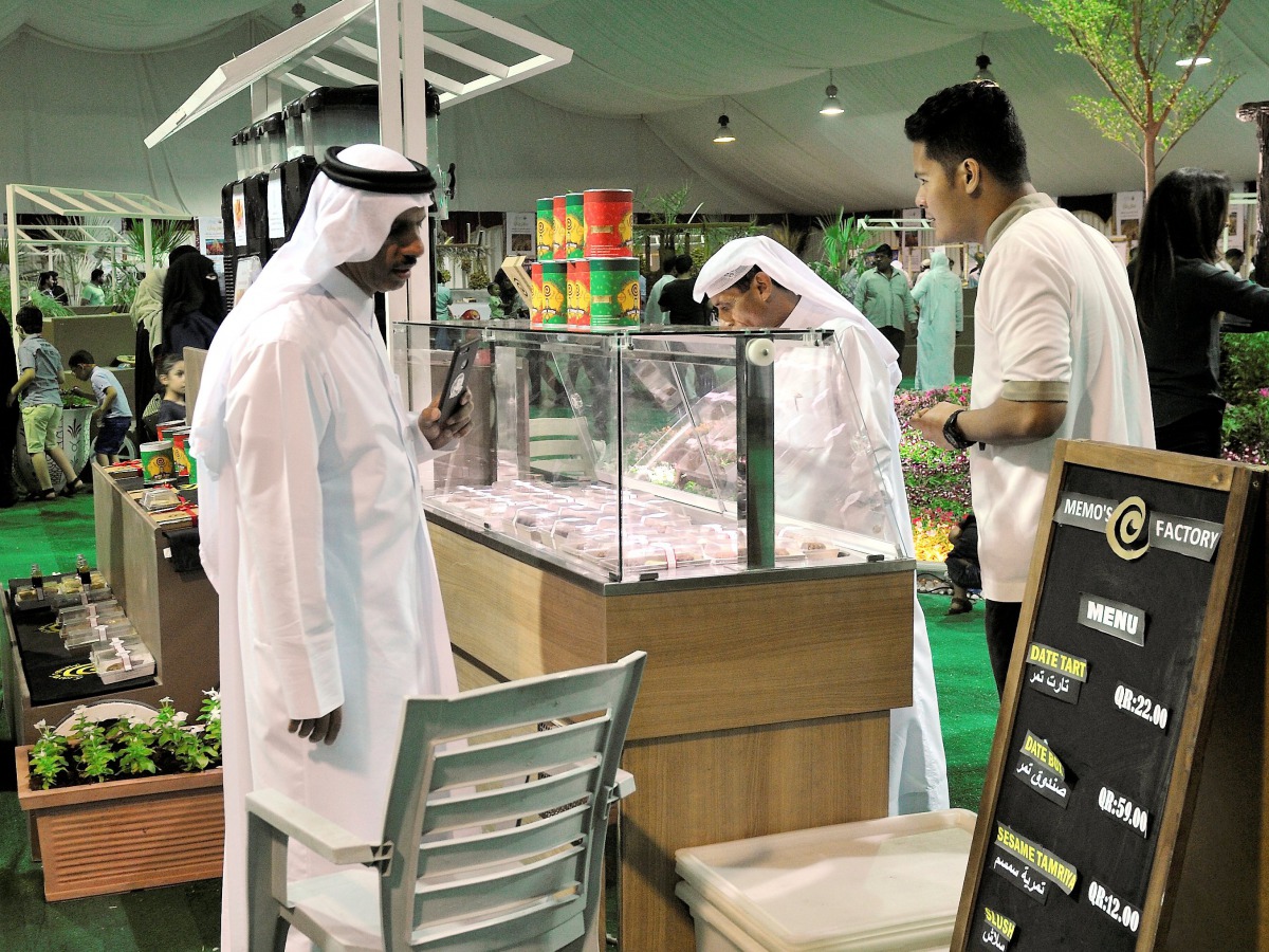 People buying vegan cake, juice and Ice cream made with organic dates at a stall at the second Local Dates Festival 2017 at Souq Waqif yesterday. (Pic: Kammutty VP / The Peninsula)