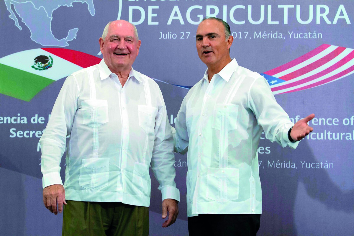 US Agriculture Secretary Sonny Perdue (left) and his Mexican counterpart Jose Calzada pose for pictures after offering a joint press conference in Merida, Yucatan State, Mexico. Perdue and Calzada met for talks on agricultural trade issues ahead of the re