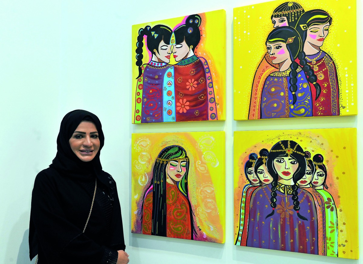 Qatari artist Lina Al Ali with her paintings on display at the “50X50” exhibition at Al Markhiya Gallery at Katara Art Centre. Pic: Kammutty V P / The Peninsula
