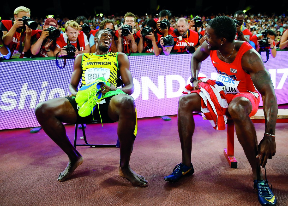 Usain Bolt of Jamaica (left) sits on a bench with Justin Gatlin of US after the men’s 200 metres final during the 15th IAAF World Championships at the National Stadium in Beijing, in this August 27, 2015 file photo.