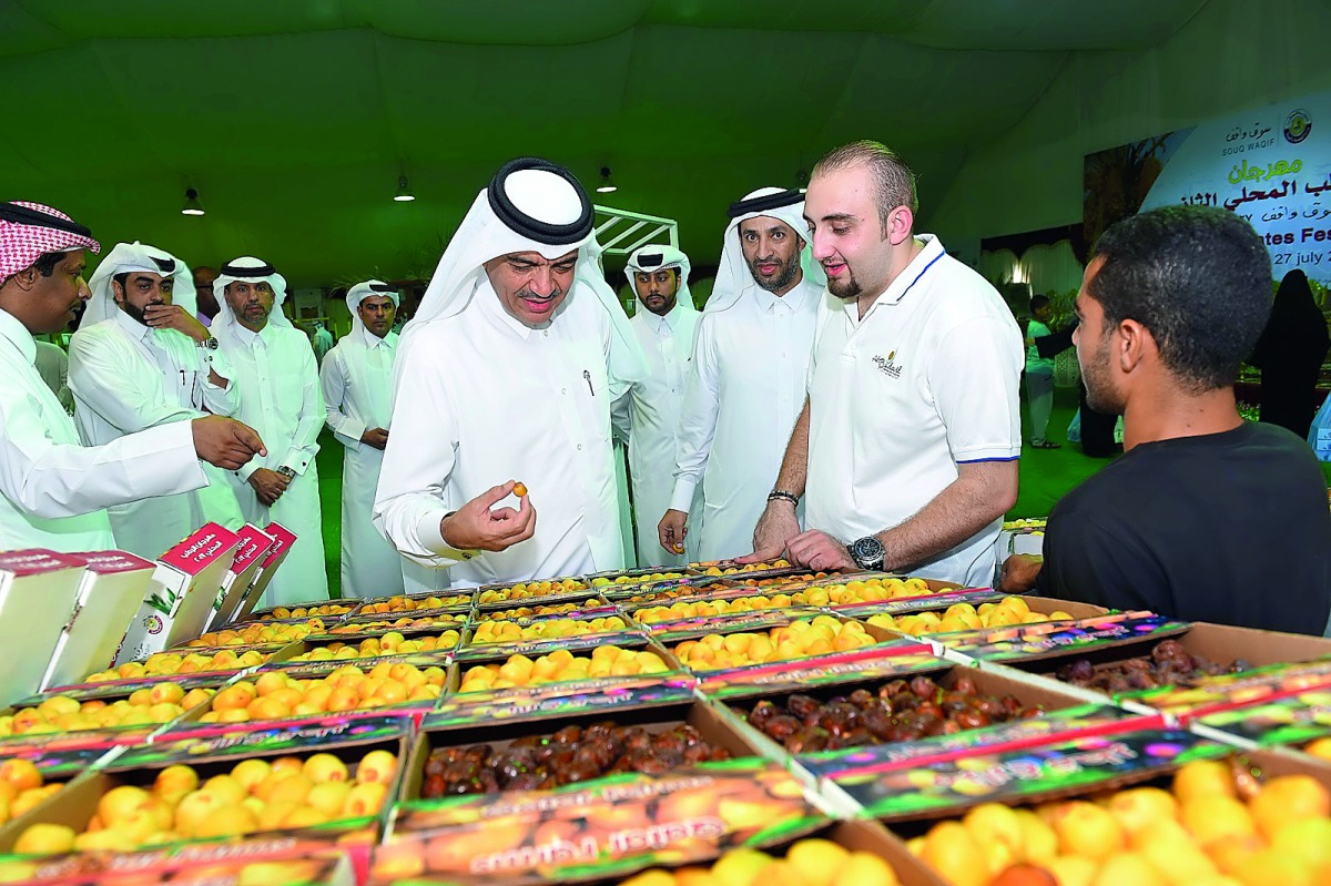 Minister of Municipality and Environment H E Mohammed bin Abdullah Al Rumaihi taking a tour at the dates festival at Souq Waqif, yesterday.