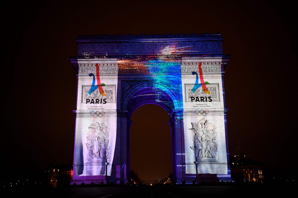 This file photo taken on December 31, 2016 during the New Year celebration shows an image projected on the Arc de Triomphe monument during a laser and 3D video mapping show on the theme of the Paris bid for the 2024 Olympic Games. Los Angeles formally ann
